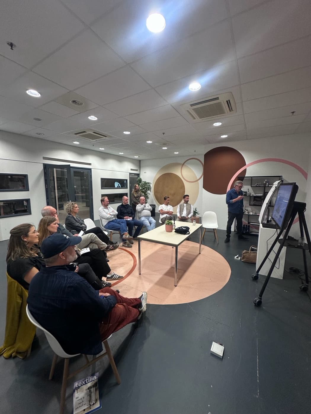 Attendees seated in a circle during a round-table session at CAST in Nieuwegein.