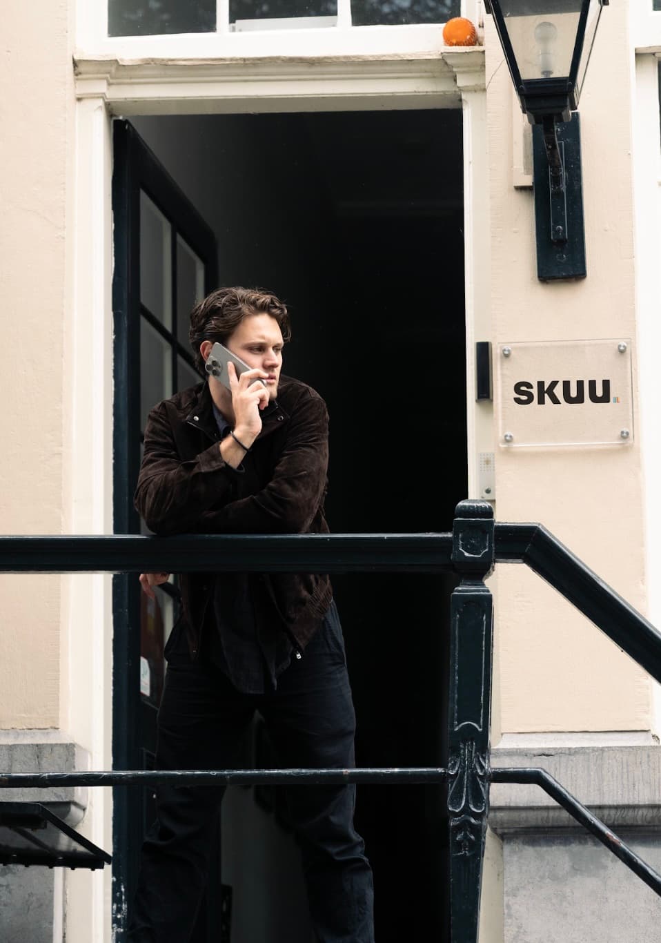 On the phone at the front door of the SKUU office in Amsterdam.